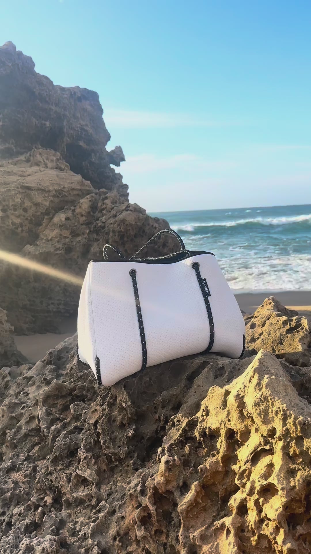 Classic white tote on the beach placed on a rock showing the quality 