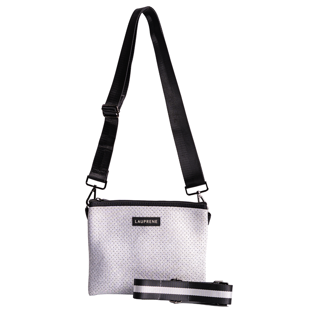 Lauprene light grey cross body messenger bag with a solid black  adjustable strap and additional black and white stripe adjustable strap